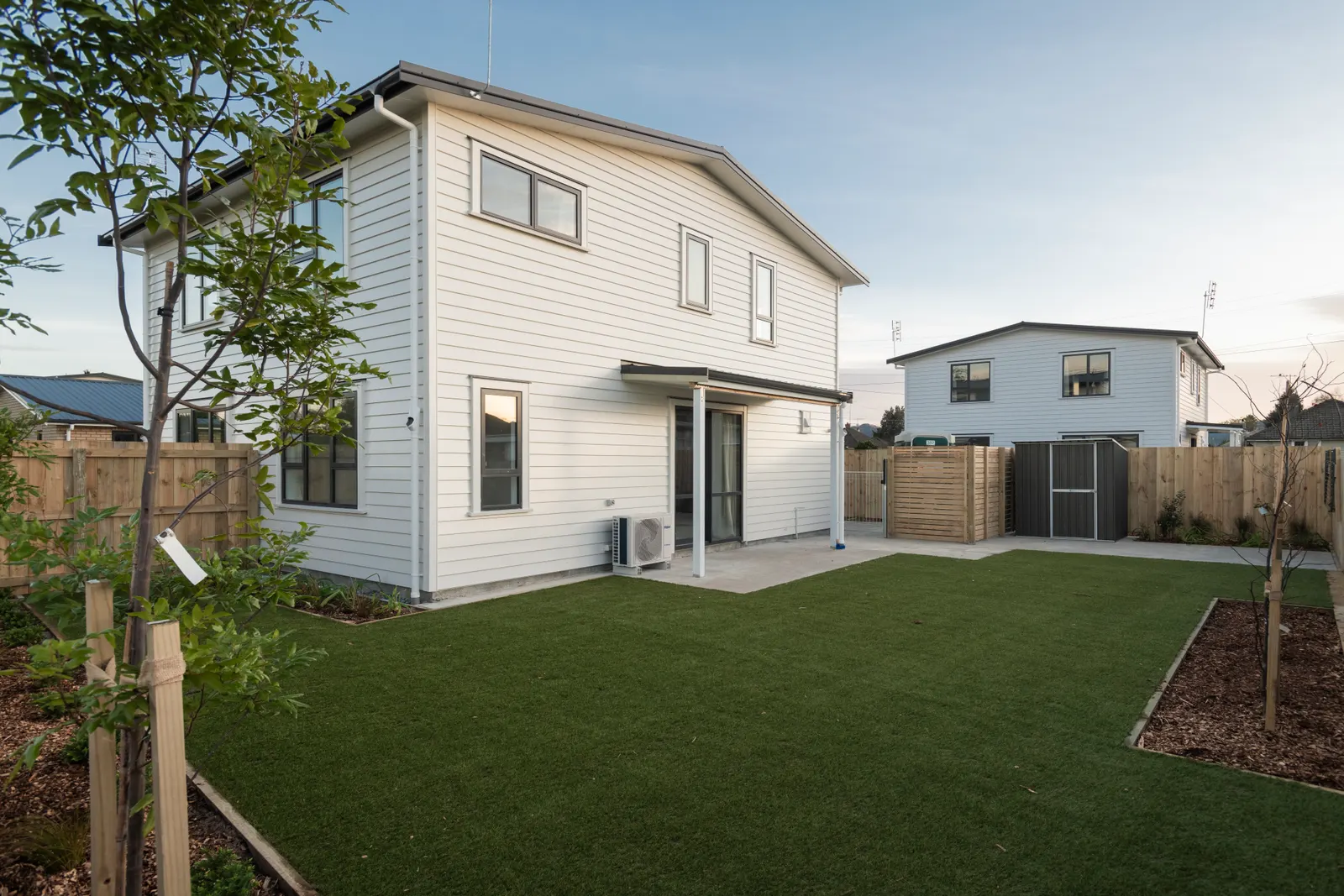 Fresh astroturf lawn beside a new build in Gisborne